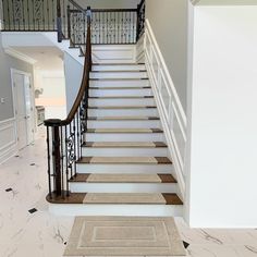 there is a stair case in the middle of this room with carpet on the floor