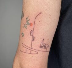 a person with a small tattoo on their arm that has an image of a street light