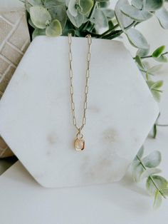 Take your style to the next level with the Aria Necklace! This chic and elegant statement accessory features a 16K gold filled baguette multifaceted natural gemstone charm, hanging from a paperclip chain. Details - Gold filled chain, about 17.8 inches in length - Gold filled pendant, about 12.8mm x 6.7mm in size - Lead Free, Nickel Free Paperclip Necklace With Charm, Paperclip Necklace, Business Photoshoot, Chic And Elegant, Jewelry Case, Gold Filled Chain, Stationery Notebook, Paper Clip, Clear Quartz