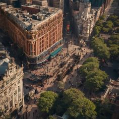 an aerial view of a city street with lots of tall buildings and trees in the foreground