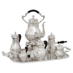 an ornate silver tea set on a tray