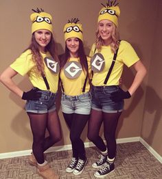 three girls in minion costumes standing next to each other with their hands on their hipss