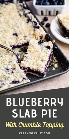 blueberry slab pie with crumble topping on a baking sheet and plate next to it