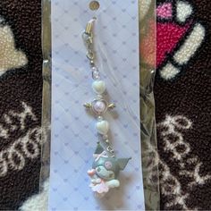 a keychain with an animal charm on it's side in a package