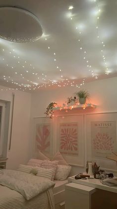 a bedroom with some lights on the ceiling