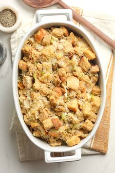 thanksgiving stuffing with chicken in a white casserole dish