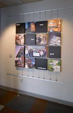 a group of pictures hanging on the wall next to a window in an office building