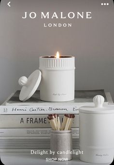 the candle is on top of some books and matchesticks in front of it