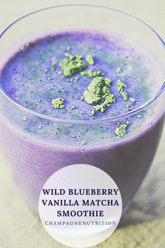 a blueberry vanilla matcha smoothie in a glass with the words wild blueberry vanilla matcha smoothie