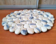 a pile of white and blue rocks sitting on top of a wooden floor next to a door