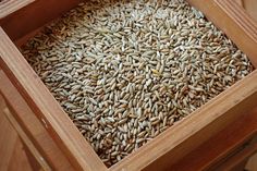 a wooden box filled with lots of seeds