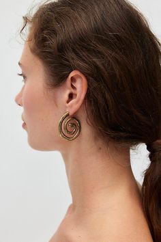 Swirly burnished hoop earrings in a medium silhouette complete with an antiqued finish. Features Swirly burnished hoop earrings Chunky swirl hoop earrings Burnished antiqued finish Choose from silver or gold hoop earrings Post backing Content + Care Mixed metal Avoid contact with water Imported | Swirly Burnished Hoop Earring in Gold, Women's at Urban Outfitters Hoop Earrings Chunky, Antique Finish, Mixed Metals, Gold Hoop, Gold Hoop Earrings, Post Earrings, Swirl, Urban Outfitters, Sign Up