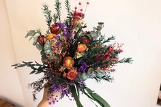 a person holding a bouquet of flowers in their hand