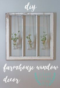 an old window is decorated with flowers and hanging from the wall, as well as some words that read diy farmhouse window decor