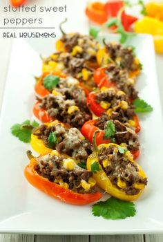 stuffed peppers with meat and vegetables on a white plate