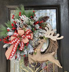 a christmas wreath with deer and pine cones