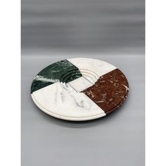 marble coasters with different colors and designs on each side, sitting on a gray surface