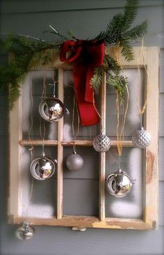 an old window is decorated with christmas ornaments