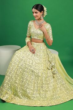 Lemon yellow lehenga with attached can can and sequin embroidered floral motifs. Comes with padded blouse and dupatta.
Components: 3
Pattern: Embroidered
Type Of Work: Thread, Sequin
Neckline: V-neck
Sleeve Type: Half
Fabric: Georgette
Color: Yellow
Other Details: 
Attached lining
Lehenga Length: 42 inches
Model Height: 5ft 4inches wearing size S
Closure: 
Lehenga: Side drawstring
Blouse: Back hook
Occasion: Mehendi and Haldi,Sangeet - Aza Fashions Traditional Pista Green Dress With Sequins, Designer Pista Green Sequin Dress, Embellished Yellow Sets For Diwali, Embellished Yellow Set For Diwali, Embellished Yellow Sets For Reception, Pista Green Sequined Dress, Diwali Embellished Yellow Sets, Yellow Embellished Choli For Eid, Yellow Embellished Bollywood Set