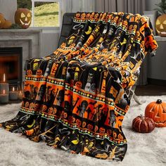 a living room filled with furniture covered in halloween themed blankets