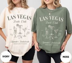 two women standing next to each other wearing las vegas t - shirts