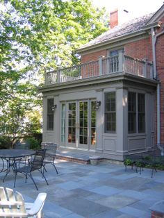 an outdoor patio with tables and chairs