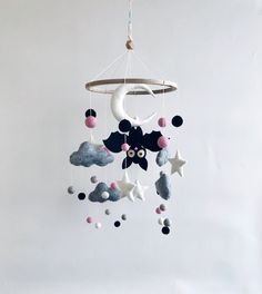 a mobile with stars and clouds hanging from it