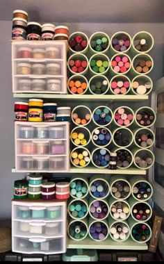 the shelves are filled with many different types of paint and crafting supplies on them