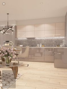 a modern kitchen and dining room are shown in this artist's rendering, with light wood flooring