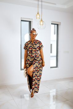 The Nomadi maxi wrap dress is a versatile piece ideal for any season. Crafted from 100% African print cotton, it combines comfort with striking style. The dress is fully lined and measures approximately 61 inches in length, ensuring a flattering fit for various body types. It pairs beautifully with a matching head wrap to complete your look. The model, standing at 5'9", is wearing a size Medium, showcasing the dress's elegant drape. Perfect for both casual outings and special occasions! Ankara Wrap Dress, Modern African Print Dresses, Ankara Pants, African Clothing Stores, Modern African Clothing, Model Standing, Elegant Drapes, African Print Dress, African Print Dresses