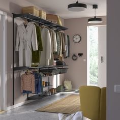 an open closet with clothes hanging on shelves and a chair in the corner next to it