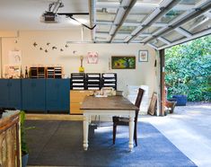 the inside of a garage with lots of storage and furniture on it's walls