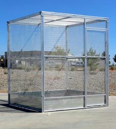 a large metal cage sitting on the side of a road