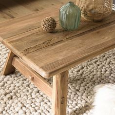 a wooden table sitting on top of a white rug