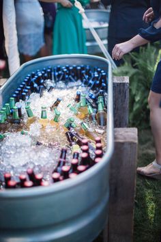 people are gathered around an ice bucket filled with beer