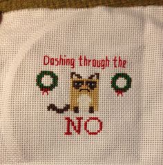 a cross - stitch design on a white cloth with the words dashing through the no