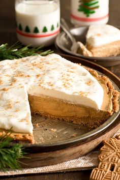 a slice of pumpkin pie on a plate with graham crackers next to the pie