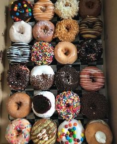 a box filled with lots of different flavored donuts