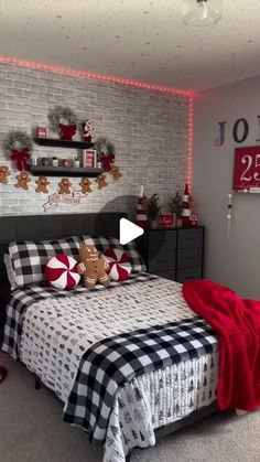 a bed room with a neatly made bed and christmas decorations on the wall above it