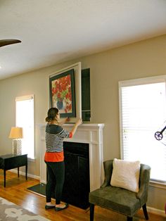 a woman standing in front of a fire place