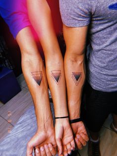 two people with matching tattoos on their arms