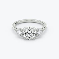 an engagement ring with three stones on the side