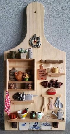 a wooden cutting board with various kitchen utensils on it's sides and shelves