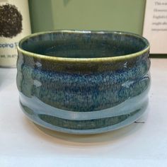 a blue and green bowl sitting on top of a table