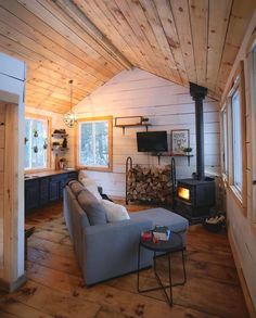 a living room filled with furniture and a fire place in the middle of a room