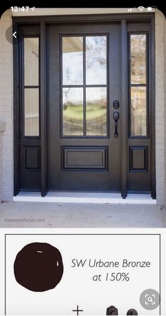 the front door is painted black and has brown stain on it, with an advertise