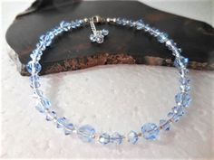 "This Crystal ankle bracelet is the perfect Something Blue for the Bride or for that dazzling finishing touch to any outfit. Get your sparkle on with light blue premium quality crystals that sparkle and shimmer around your ankle, sure to dazzle all who see it. The sterling silver clasp and chain make it adjustable for a comfortable fit and ends in a flirty crystal dangle. The pictured anklet will fit an ankle 9\" to 10\" depending on where you want it to sit (9\" is considered average size for w Elegant Blue Anklets For Gifts, Elegant Blue Anklets For Gift, Adjustable Blue Anklets For Party, Blue Beaded Anklets For Party, Adjustable Blue Anklets As Gift, Blue Anklets With Round Beads For Gift, Blue Round Beads Anklets For Gifts, Something Blue For Bride, Pearl Ankle Bracelet