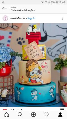 a multi layer cake decorated with cartoon characters and writing on the top, surrounded by other decorations