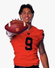 a man in an orange jersey holding a football