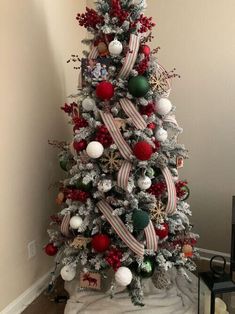 a decorated christmas tree with red, white and green ornaments